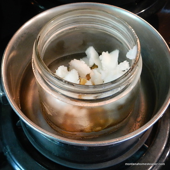 How to make easy DIY dandelion salve melting ingredients in infused oil in a double boiler