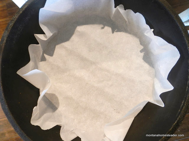 lining a dutch oven with parchment paper for easier clean up after baking
