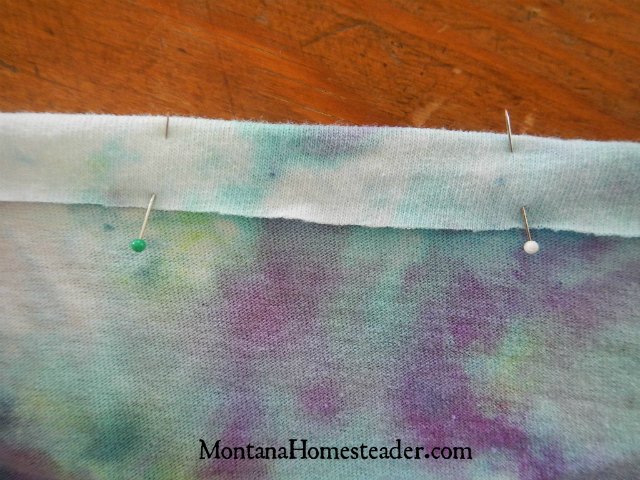 How to upcycle a t shirt into a girls skirt with minimal sewing folding the waistband down to create a casing to put in the elastic when making a skirt from a t shirt