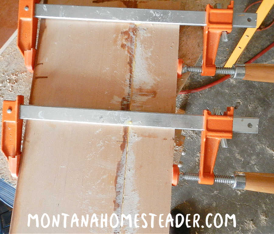 gluing and clamping wood together to make a langstroth bee hive from recycled materials