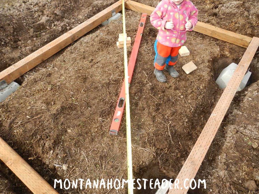 How to stabilize a greenhouse for wind and snow anchor it to the ground on wood concrete piers checking it is square and level