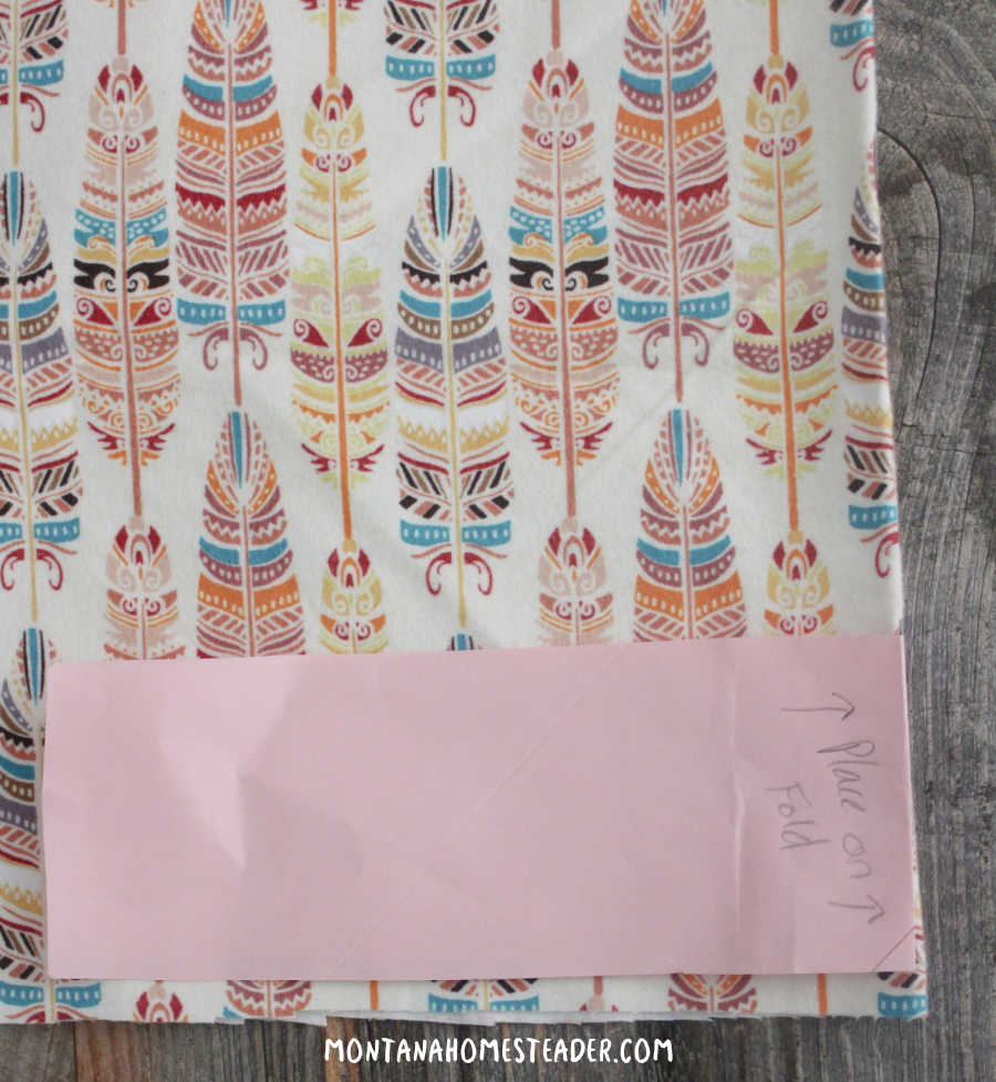 How to make an easy DIY hair scrunchie start by making a simple pattern on paper and place on fabric fold to cut out the fabric strip